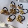 Luxe Metallic Lily Hair Tie – Golden Flower Elastic Band - Image 2