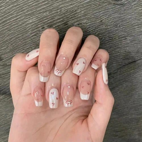 Sweet Bow Charm Press-On Nails 💕🎀 – Elegant Nude Nails with Cute Red Bow & Heart Accents